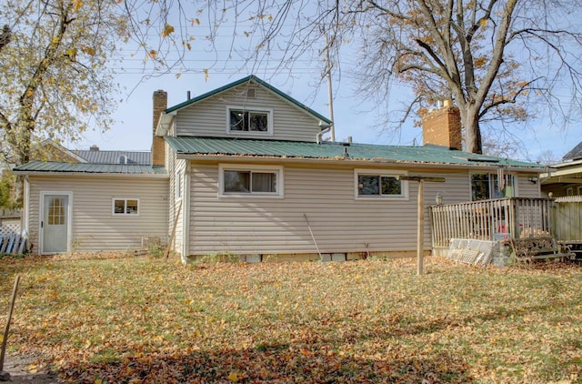 rear view of property featuring a deck and a yard