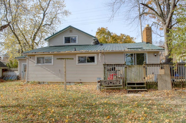 back of house with a wooden deck and a yard