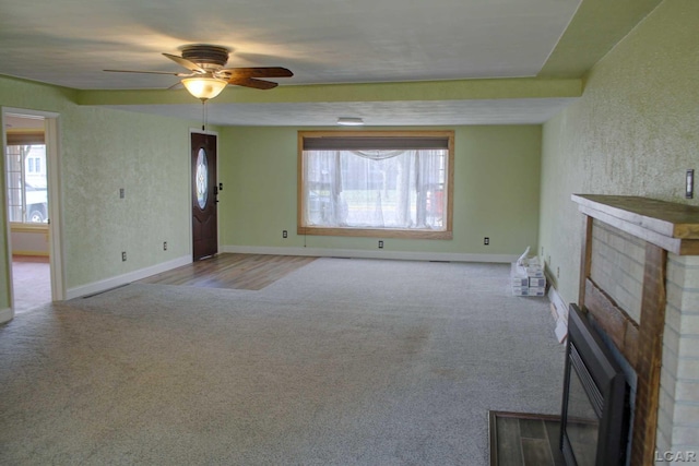 unfurnished living room with light colored carpet and ceiling fan