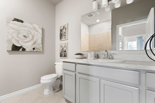 bathroom with tile patterned flooring, vanity, toilet, and walk in shower