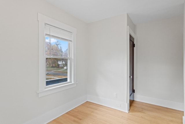 unfurnished room with hardwood / wood-style flooring