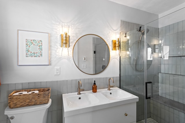 bathroom with vanity, toilet, walk in shower, and tile walls