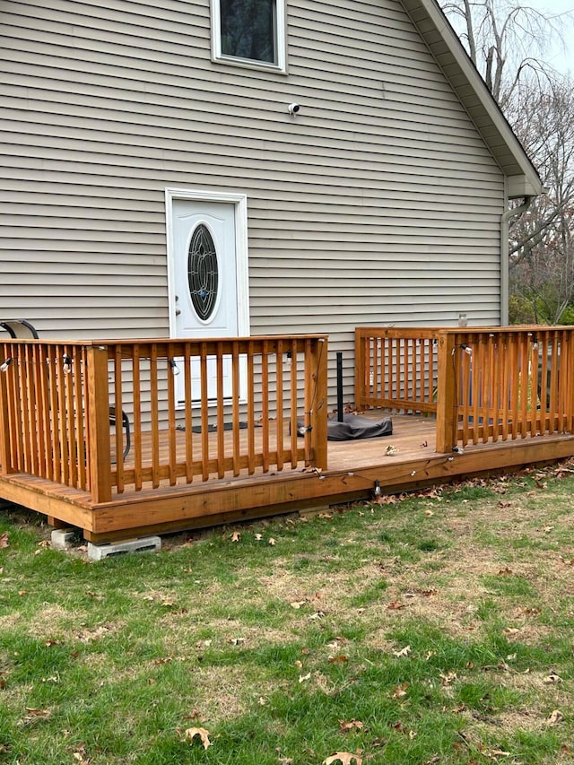 wooden terrace featuring a yard