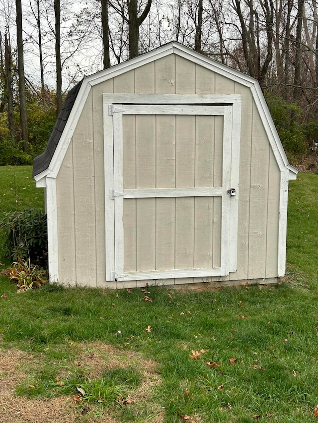 view of outbuilding with a lawn