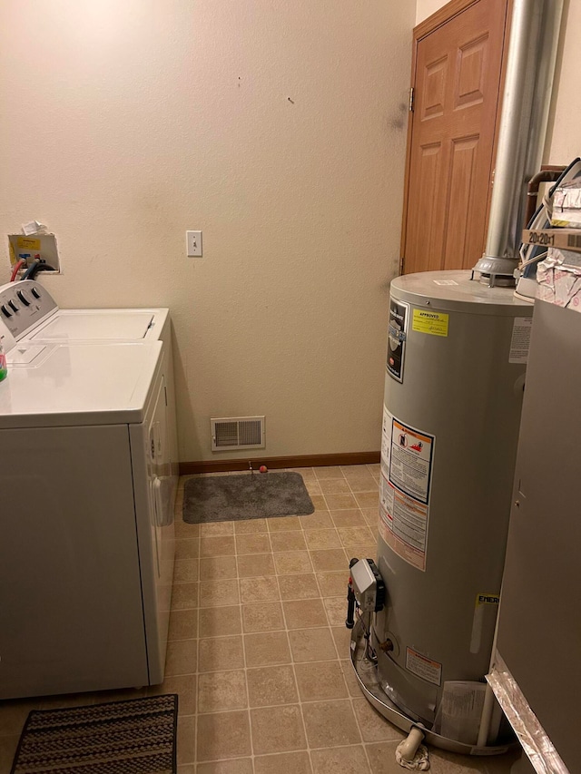 washroom with separate washer and dryer, water heater, and light tile patterned flooring