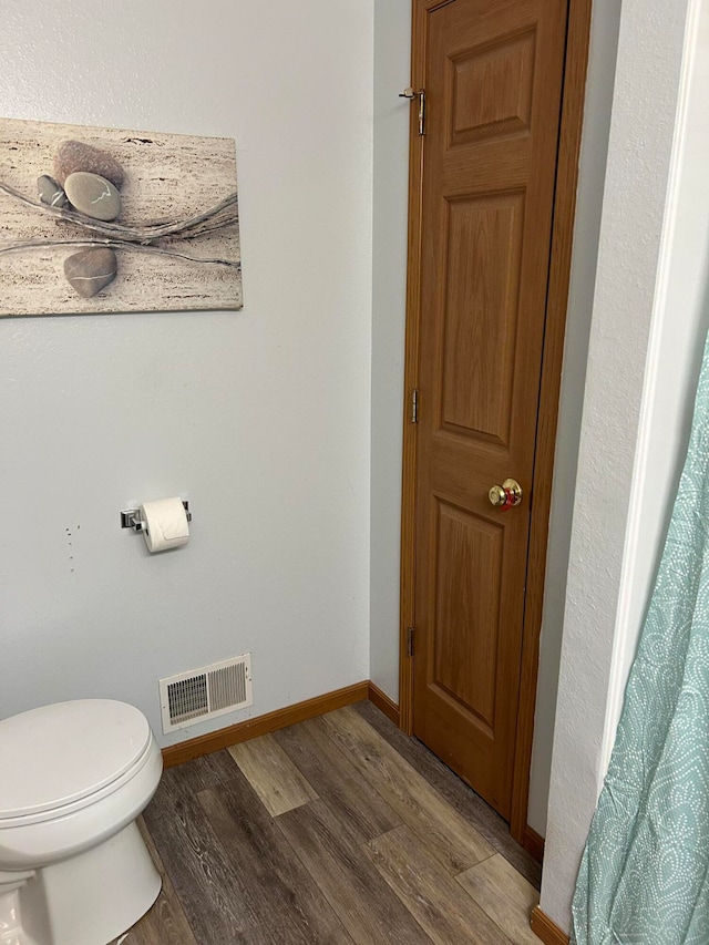 bathroom featuring toilet and hardwood / wood-style flooring