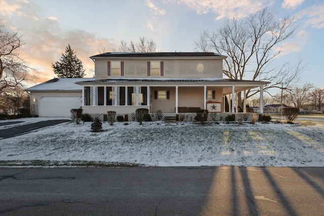 farmhouse-style home featuring covered porch and a garage