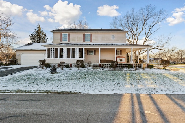 farmhouse-style home featuring a porch and a garage