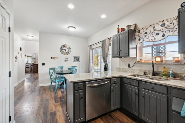 kitchen featuring dishwasher, kitchen peninsula, light stone countertops, and sink