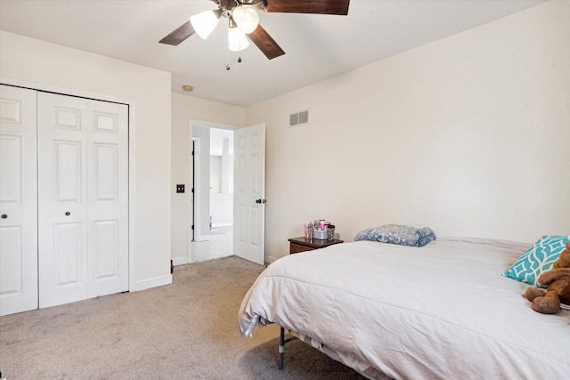 carpeted bedroom featuring a closet and ceiling fan