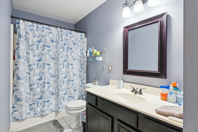 bathroom featuring tile patterned flooring, vanity, and toilet