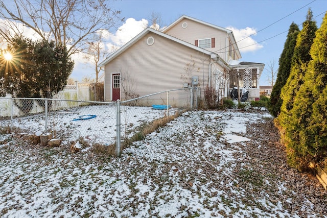 view of snow covered rear of property