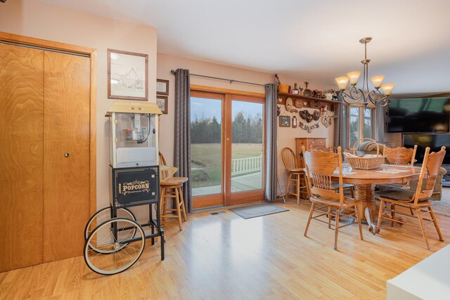 5085 W Redstone Rd, Michigan, MI 48880 - dining space with a chandelier and wood finished floors