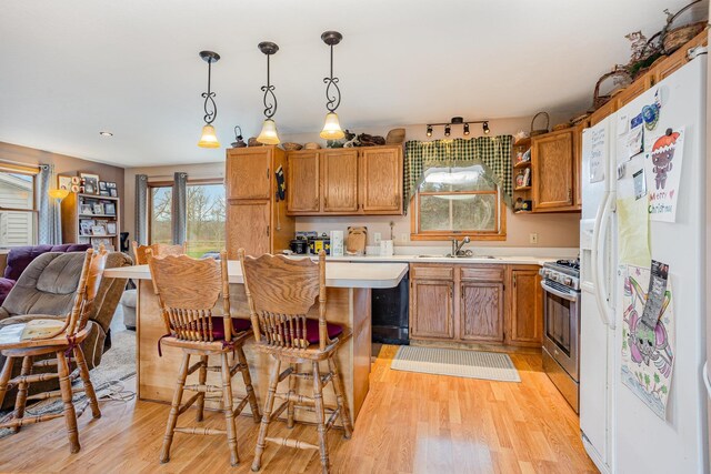 5085 W Redstone Rd, Michigan, MI 48880 - kitchen featuring white refrigerator with ice dispenser, a sink, light countertops, light wood finished floors, and stainless steel gas stove