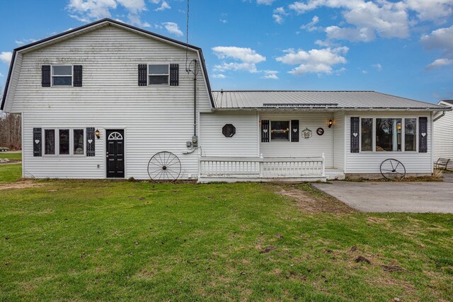 5085 W Redstone Rd, Michigan, MI 48880 - rear view of property featuring a yard, metal roof, and a patio
