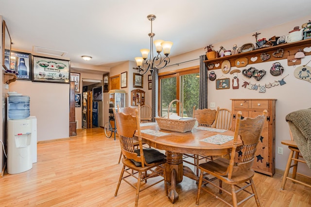 dining room featuring a chandelier and light hardwood / wood-style floors