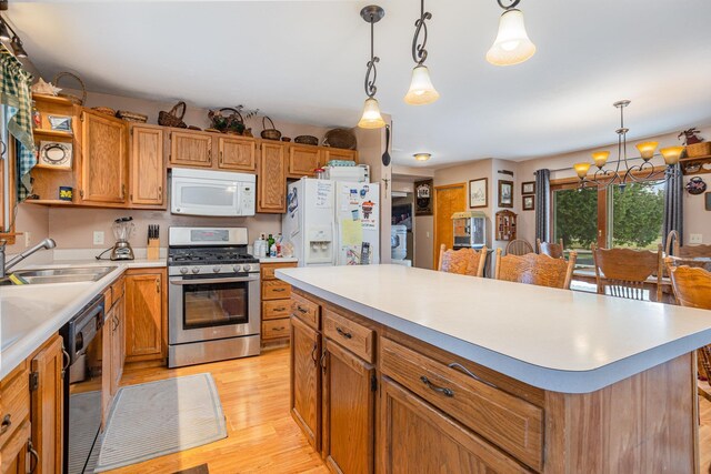 5085 W Redstone Rd, Michigan, MI 48880 - kitchen featuring white appliances, a sink, light wood-type flooring, a chandelier, and light countertops