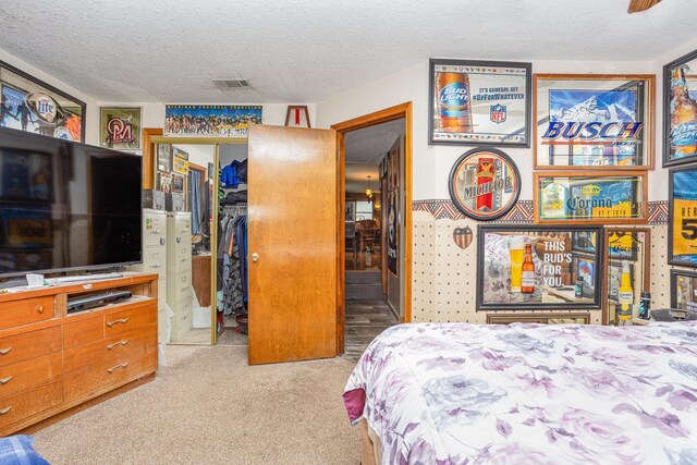 5085 W Redstone Rd, Michigan, MI 48880 - carpeted bedroom featuring a textured ceiling, a closet, and a spacious closet