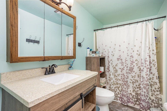 bathroom with vanity, toilet, and walk in shower