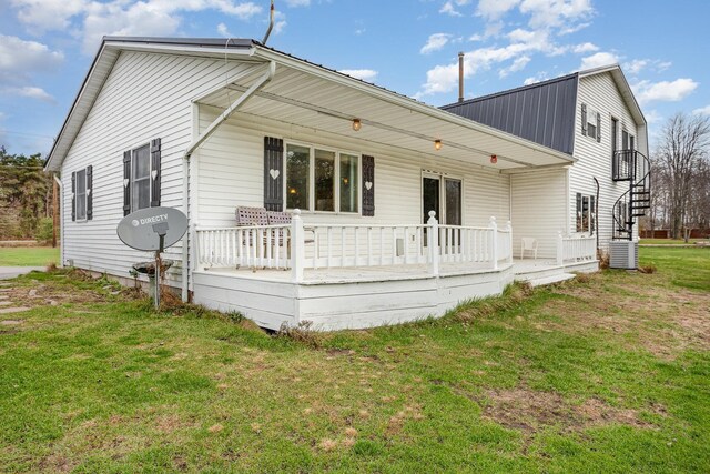 5085 W Redstone Rd, Michigan, MI 48880 - back of house featuring a yard, central air condition unit, and metal roof