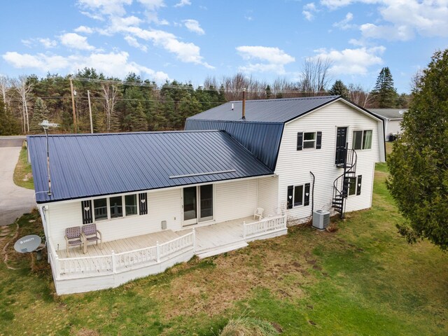 5085 W Redstone Rd, Michigan, MI 48880 - back of property featuring cooling unit, metal roof, a lawn, and a wooden deck