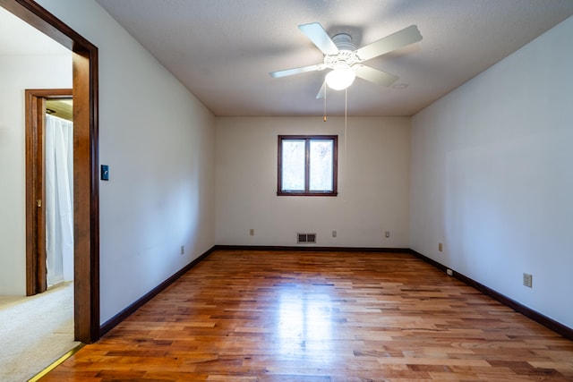 unfurnished room with ceiling fan, a textured ceiling, and hardwood / wood-style flooring