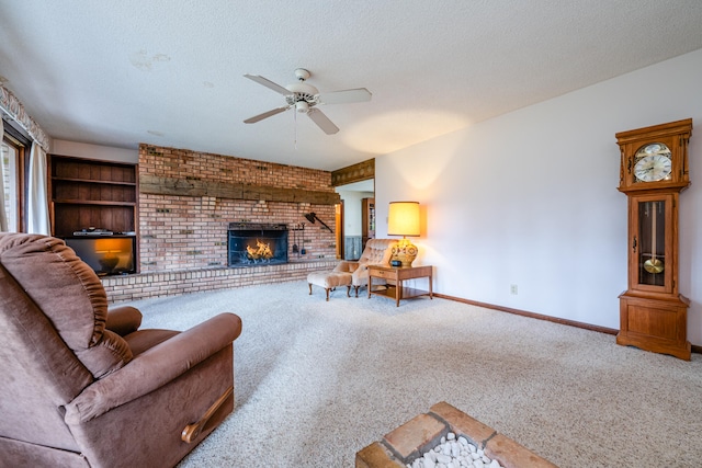 living room with carpet, ceiling fan, a fireplace, and a textured ceiling