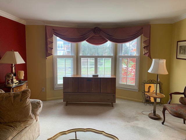 living area featuring light carpet, plenty of natural light, and ornamental molding