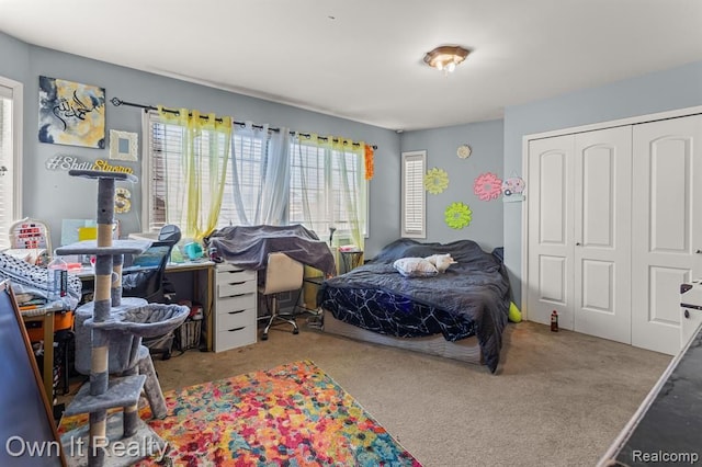 bedroom with light carpet and a closet