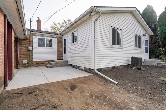 back of house featuring cooling unit and a patio area