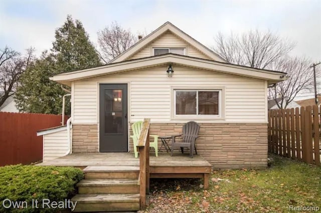 back of property featuring a wooden deck