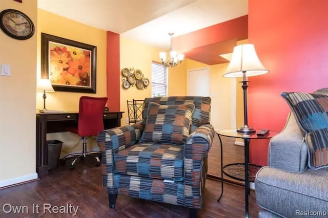 sitting room with dark hardwood / wood-style flooring and a notable chandelier