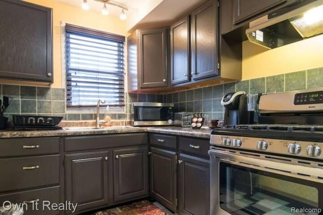 kitchen featuring backsplash, sink, exhaust hood, and appliances with stainless steel finishes