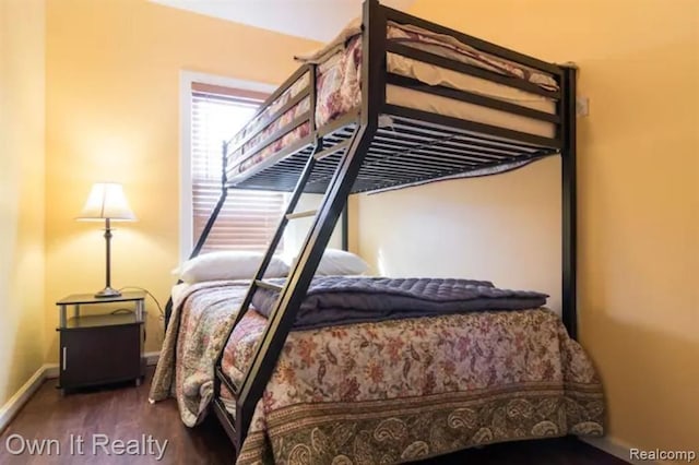 bedroom with dark hardwood / wood-style flooring