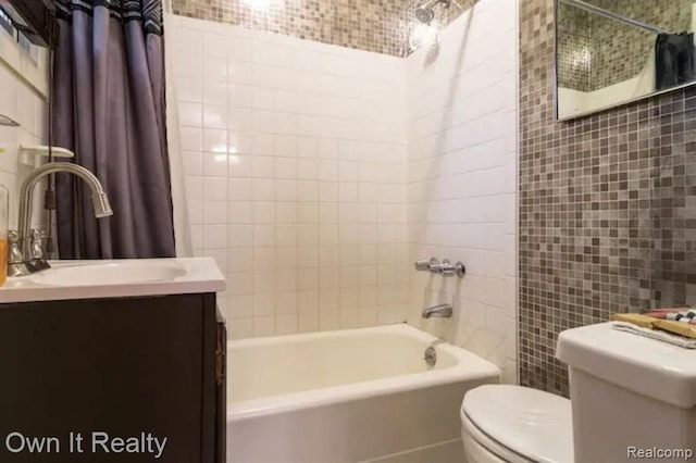 full bathroom featuring toilet, vanity, shower / tub combo with curtain, and tile walls