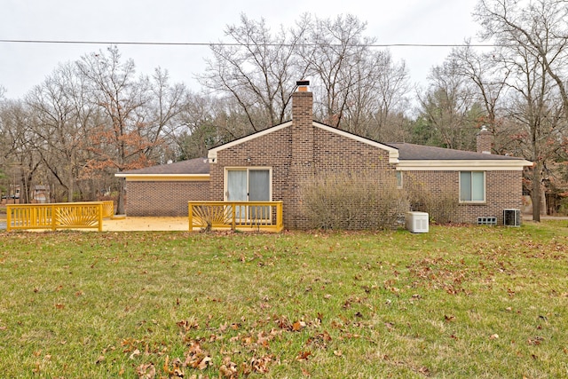 back of property with a patio area, a yard, and central air condition unit