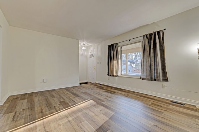 empty room with light hardwood / wood-style floors