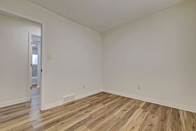 spare room with light hardwood / wood-style flooring and ornamental molding