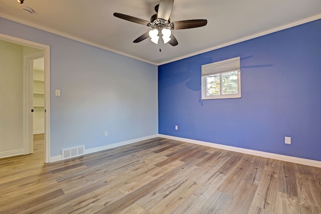 spare room featuring ceiling fan, light wood-type flooring, and ornamental molding