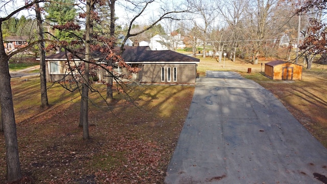 ranch-style house featuring a shed