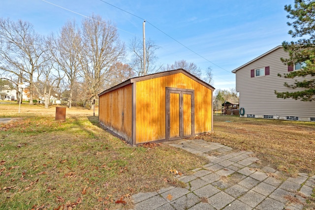 view of outbuilding featuring a lawn