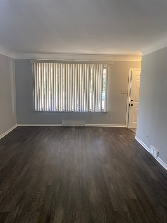 empty room with dark hardwood / wood-style flooring