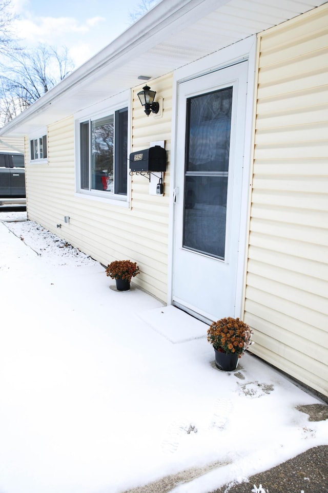 view of snow covered property entrance