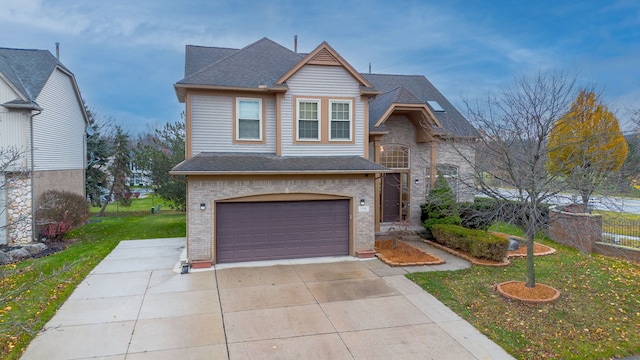 view of front of home with a front lawn and a garage