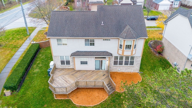 rear view of house with a yard and a deck