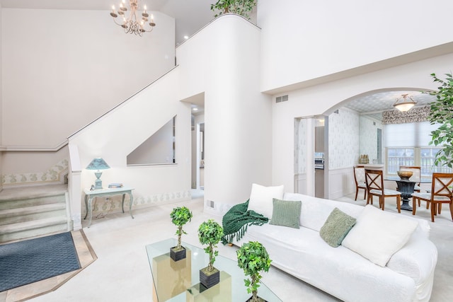 living room with a notable chandelier and high vaulted ceiling