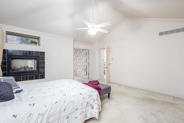 carpeted bedroom with a tile fireplace, ceiling fan, lofted ceiling, and ornamental molding