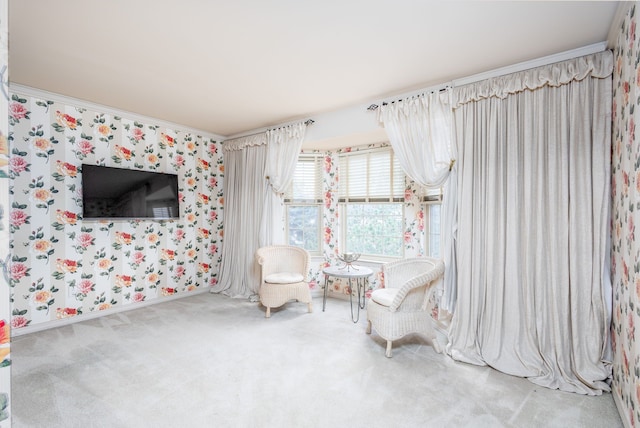 living area with carpet and crown molding