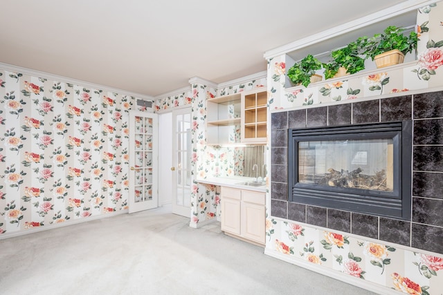 bathroom featuring vanity, crown molding, and a fireplace