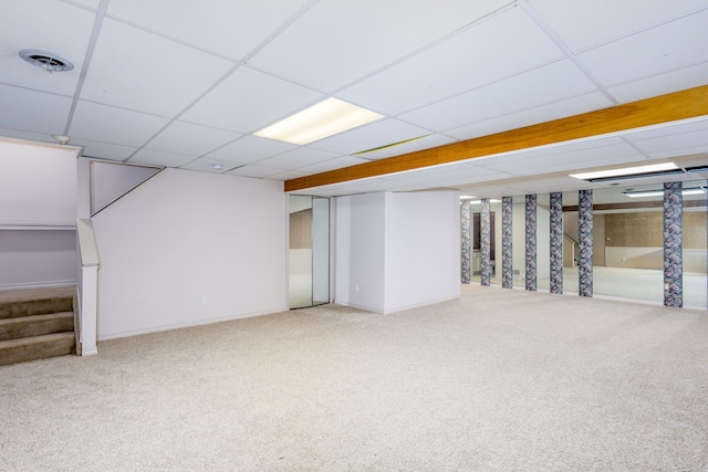 basement featuring carpet flooring and a drop ceiling